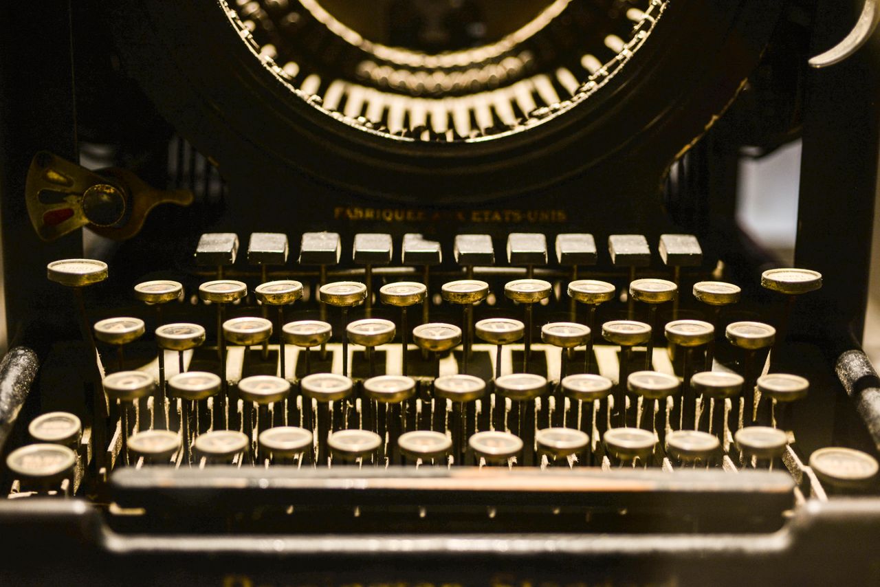 Close-up of a vintage typewriter showcasing its keys and mechanical parts.